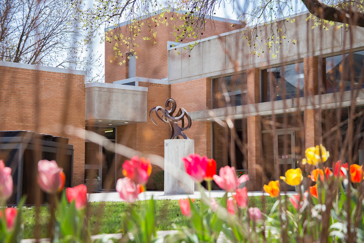 Close up of Dulaney Dining Hall entrance with mass of tulips in bloom.