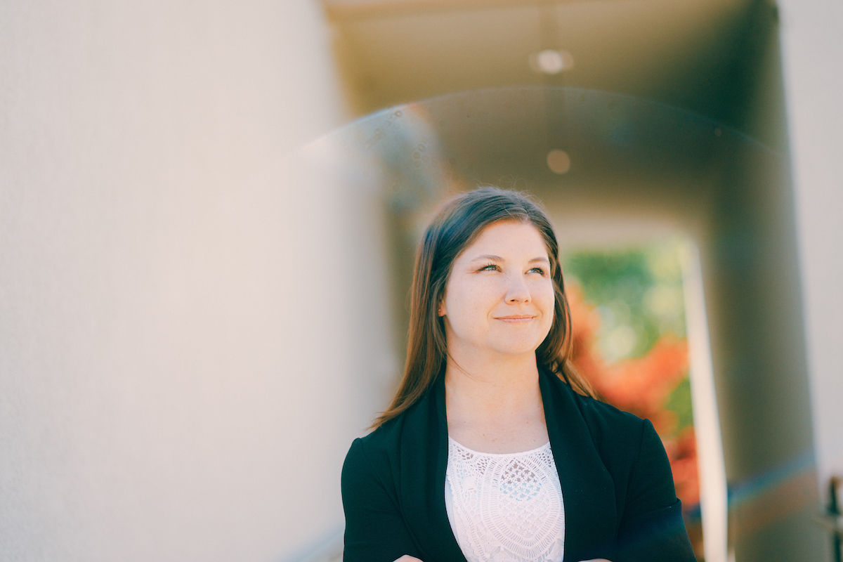 Business student glancing up to her left at the sky.