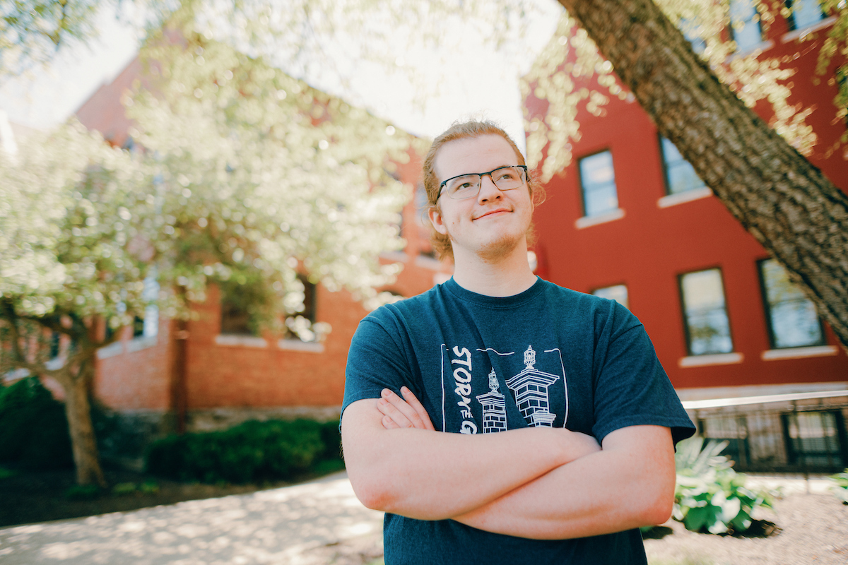 Student wearing glasses and a Storm the Gate t-shirt.