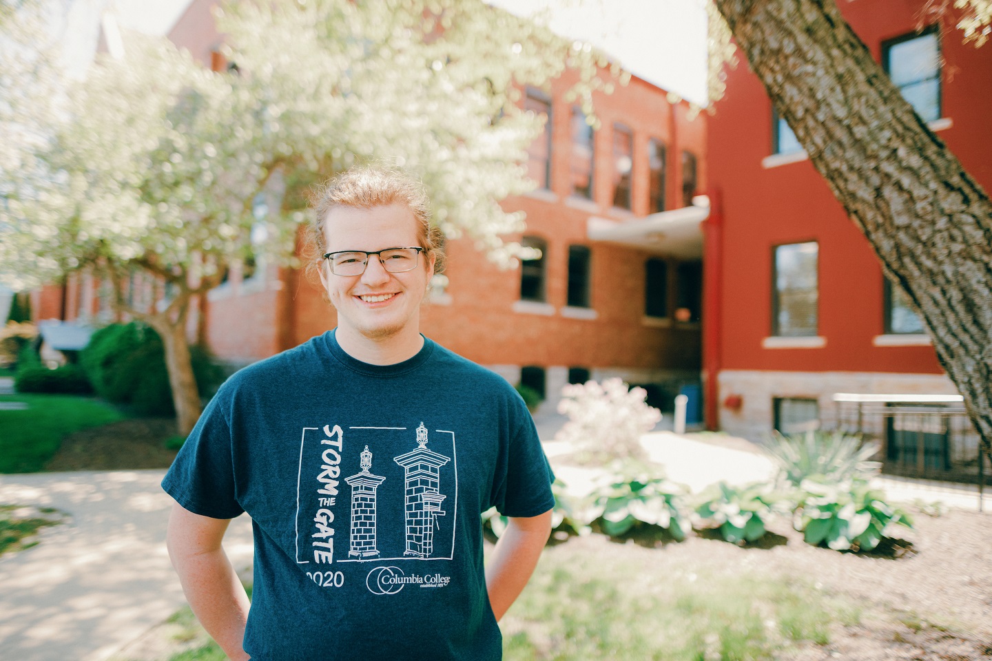 International: Student wearing glasses and a Storm the Gate 2020 t-shirt.