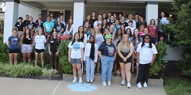 A group image of all TRiO students in front of the Columbia House, smiling at the camera.